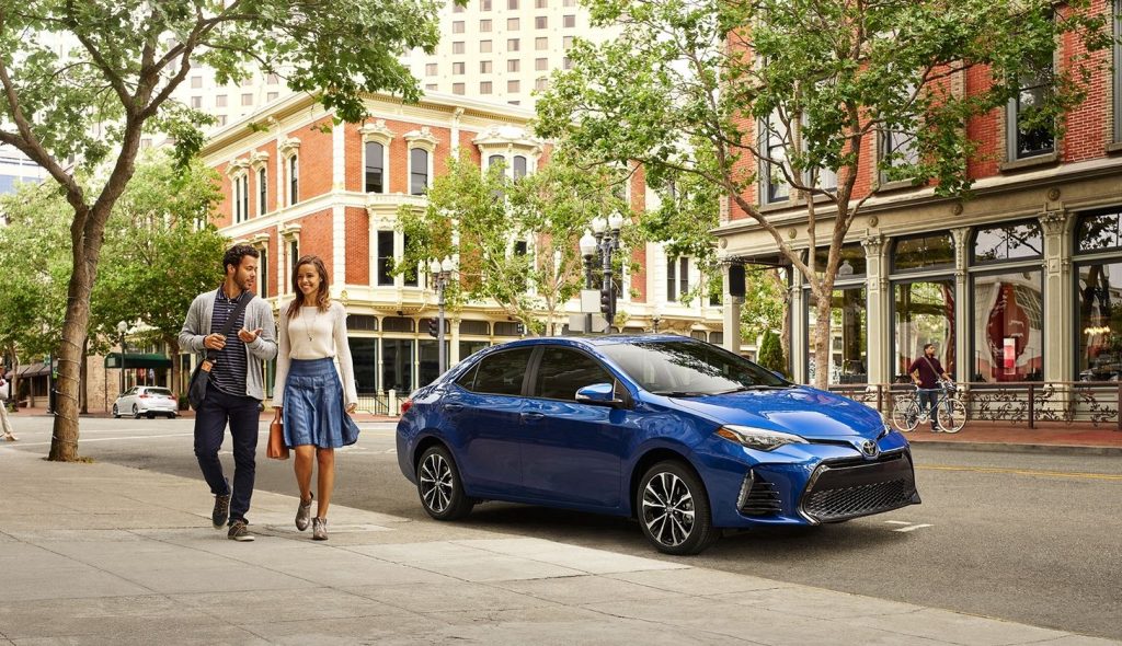 Blue Toyota Corolla parked on a city street